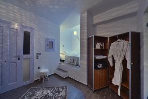 a room with a bedroom with a bed and a closet at AMO Folegandros in Karavostasi
