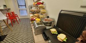 a buffet with sandwiches and other food in a room at Hotel Suite Home Prague in Prague