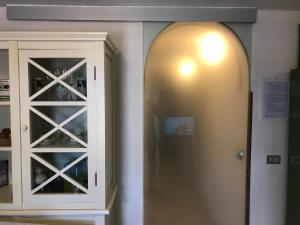 a door to a wine cellar next to a cabinet at Casa Bianca Rais Gerbi in Finale