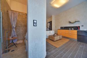 a large bathroom with a tub and a sink at AMO Folegandros in Karavostasi