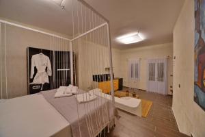 a bedroom with a white bed with a mirror at AMO Folegandros in Karavostasi