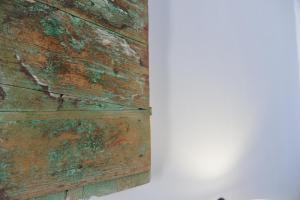 a close up of aievalieval wooden wall with green paint at AMO Folegandros in Karavostasi