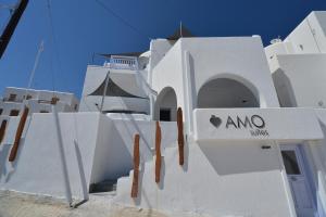 a white building with a sign on it at AMO Folegandros in Karavostasi