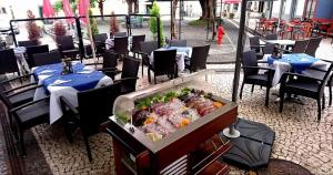 a restaurant with a buffet of food in a box at Albergaria O Professor in Santa Cruz