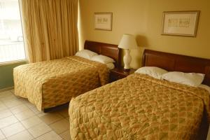 Habitación de hotel con 2 camas y ventana en Sea Cove Motel Ocean City, en Ocean City