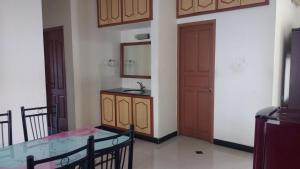 Roshini Serviced Apartments في تشيناي: مطبخ مع طاولة ومغسلة في الغرفة