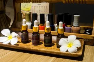 a wooden tray with bottles of essential oils and flowers at Boracay Haven Suites in Boracay