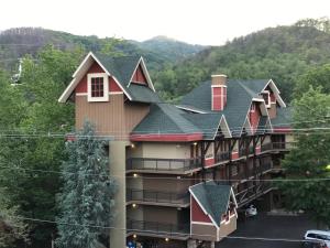 an apartment building with a gambrel roof at Downtown Gatlinburg Apartment in Gatlinburg