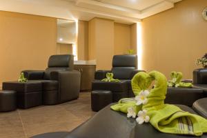 a waiting room with a green towel and chairs at Boracay Haven Suites in Boracay
