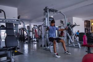 a man sitting on a treadmill in a gym at Manhattan Hotel Ipoh in Ipoh