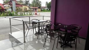 a group of black tables and chairs on a balcony at Salsa Resort Langkawi By Casa Loma in Pantai Cenang
