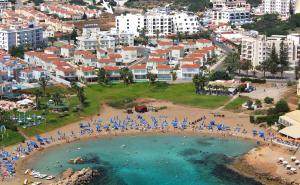 an aerial view of a beach with umbrellas and people at Seagull Hotel Apartments in Protaras