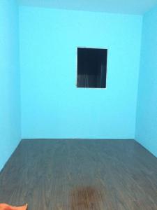 an empty room with a blue wall and a wooden floor at Saigonnais Homestay (Maison de Tran Le) in Ho Chi Minh City