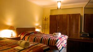 Postel nebo postele na pokoji v ubytování Kukuli Lodge B&B