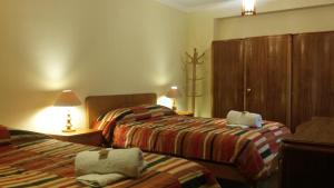 Postel nebo postele na pokoji v ubytování Kukuli Lodge B&B