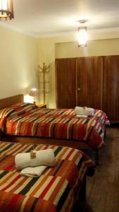 Postel nebo postele na pokoji v ubytování Kukuli Lodge B&B