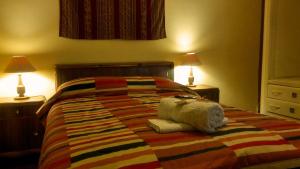 Postel nebo postele na pokoji v ubytování Kukuli Lodge B&B