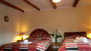 Postel nebo postele na pokoji v ubytování Kukuli Lodge B&B