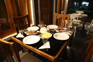 a table with plates and bowls of food on it at Pasikudah Eco Village Hotel in Pasikuda +27 photos