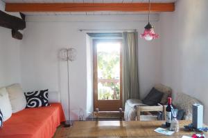 a bedroom with a bed and a table and a window at CASA LEONE - Apartements im Alto Malcantone in Breno