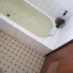 a bathroom with a mirror on a tiled ceiling at San Bu strolling in Tainan +30 photos