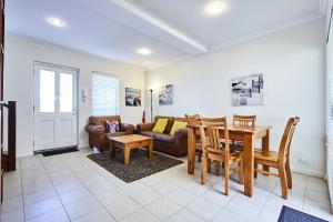 a living room with a table and a couch at Fremantle Townhouse u/5 in Fremantle
