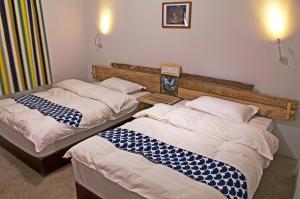 Postel nebo postele na pokoji v ubytování Lijiang Adventure Inn