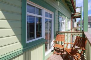 two chairs sitting on the porch of a house at Qruut Apartments in Pärnu