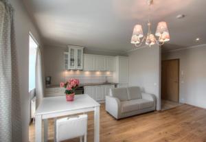 cocina y sala de estar con mesa y silla en Qruut Apartments, en Pärnu