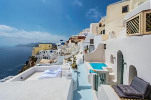 a view of a town with white buildings and the ocean at Artia Mansion in Oia