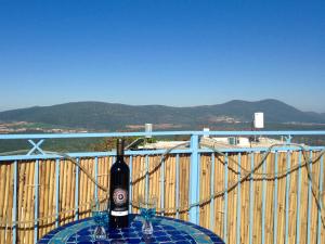 a bottle of wine sitting on a table on a balcony at Artist Quarter Guesthouse B&B in Safed