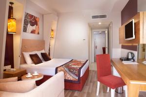 a bedroom with a bed and a living room at Orange Palace Side - All Inclusive in Side