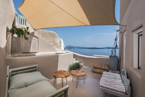 a balcony with a view of the water at Ammos Oia Mansion in Oia