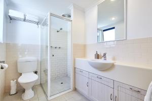 a bathroom with a toilet and a sink and a shower at Fremantle Townhouse u/5 in Fremantle