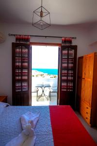 a bedroom with a bed and a view of the ocean at Domna Studios in Lindos