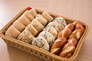 a basket filled with lots of different types of pastries at Hotel Route-Inn Uozu in Uozu