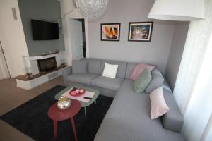 a living room with a couch and a table at Apartman Stoosova Deluxe in Zagreb