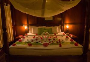 a bedroom with a bed with a wedding cake on it at The Barefoot At Havelock in Havelock Island
