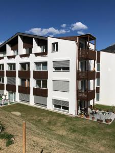 an apartment building with balconies on the side of it at Cucagna in Disentis
