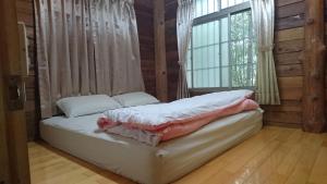 Postel nebo postele na pokoji v ubytování Zhulin View B&B