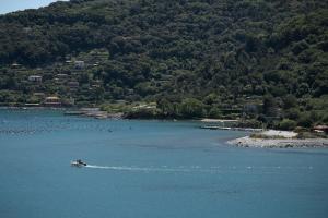 a person in a boat in the water at Grand Hotel Portovenere in Portovenere