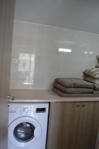 a laundry room with a washing machine and towels at Marianna Hotel Apartments in Limassol