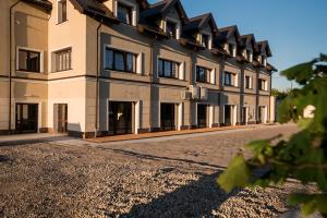 a large building with a road in front of it at Apartamenty Giżycko in Giżycko