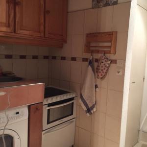 a small kitchen with a stove and a sink at Lauzes in Les Menuires