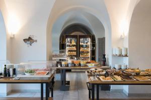 a bakery with several tables filled with different types of pastries at Grand Hotel Portovenere in Portovenere