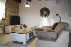 a living room with a couch and a table at Villa Harmony in Paradise in Svetvinčenat