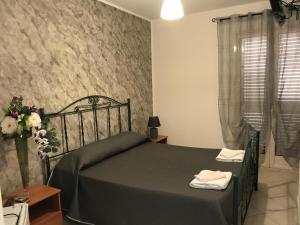 a bedroom with a bed with a black bedspread at Rosy And Roby in Gasponi