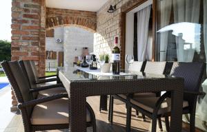 an outdoor table and chairs on a patio at Villa Harmony in Paradise in Svetvinčenat