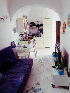 a living room with a couch and a kitchen at Casa Giovanna Gioia in Atrani +18 photos