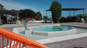 a swimming pool with an orange water slide at Oroverde in Bergeggi